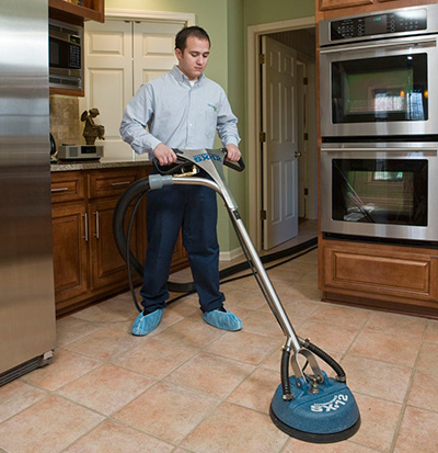 technician cleaning a kitchen floor