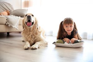 dog and young girl lying on floor