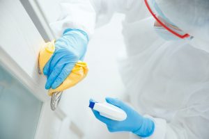 biohazard technician cleaning door handle